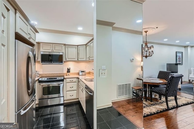 2499 Peachtree Rd Unit 108, Atlanta, GA 30305 - kitchen with stainless steel appliances, crown molding, light countertops, cream cabinetry, and recessed lighting