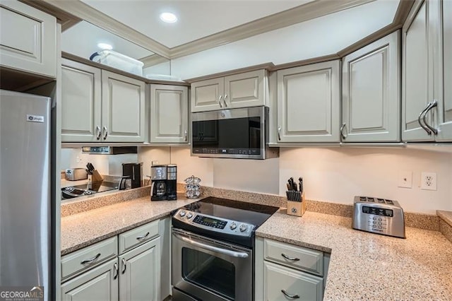 2499 Peachtree Rd Unit 108, Atlanta, GA 30305 - kitchen featuring stainless steel appliances, ornamental molding, recessed lighting, and light stone countertops