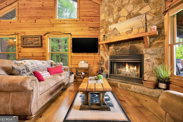 1157 Laurel Creek Rd, Blue Ridge, GA 30513 - living room with wooden walls, hardwood / wood-style floors, healthy amount of natural light, and a fireplace