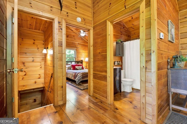 1157 Laurel Creek Rd, Blue Ridge, GA 30513 - full bathroom with wood walls, toilet, hardwood / wood-style floors, vaulted ceiling, and ceiling fan