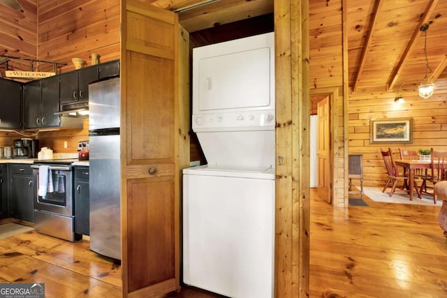 1157 Laurel Creek Rd, Blue Ridge, GA 30513 - clothes washing area with stacked washer / dryer, wooden walls, light wood-type flooring, and wood ceiling