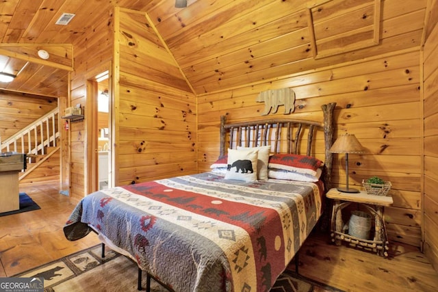 1157 Laurel Creek Rd, Blue Ridge, GA 30513 - bedroom featuring wood-type flooring, wood walls, lofted ceiling, wooden ceiling, and connected bathroom