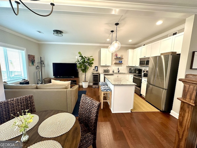 621 E 3rd St # 9, Rome, GA 30161 - kitchen with stainless steel appliances, beverage cooler, a kitchen island, wood finished floors, and white cabinetry