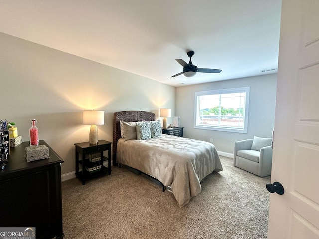 carpeted bedroom featuring baseboards and a ceiling fan