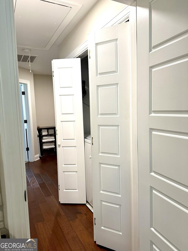 hall with attic access and dark wood-style flooring