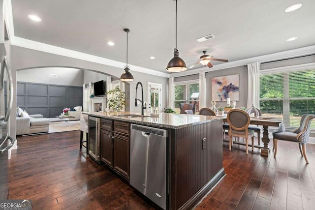 161 Archstone Sq, Mcdonough, GA 30253 - kitchen with stainless steel appliances, open floor plan, dark brown cabinets, beverage cooler, and dark wood-style floors