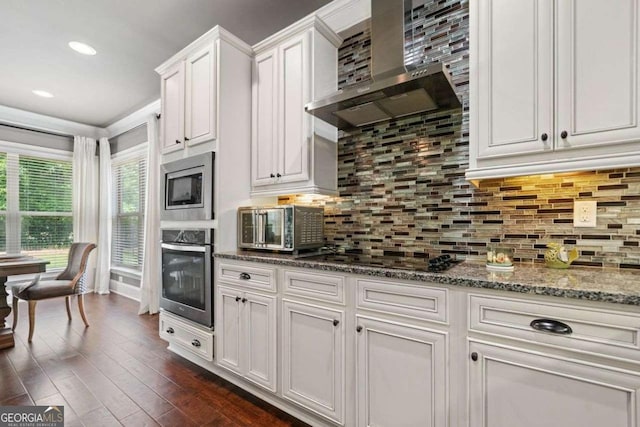 161 Archstone Sq, Mcdonough, GA 30253 - kitchen featuring stainless steel appliances, wall chimney exhaust hood, white cabinets, dark wood finished floors, and stone countertops