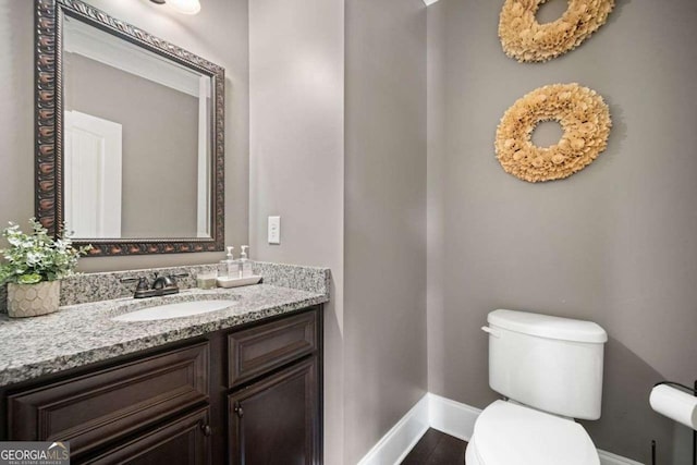 161 Archstone Sq, Mcdonough, GA 30253 - bathroom with baseboards, toilet, and vanity