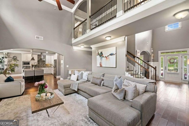 161 Archstone Sq, Mcdonough, GA 30253 - living room with a high ceiling, arched walkways, plenty of natural light, stairs, and ceiling fan