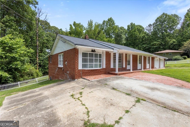 684 Hog Liver Rd, Carrollton, GA 30117 - view of front of home featuring brick siding, a porch, fence, and a chimney