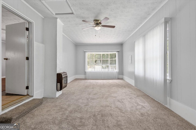 684 Hog Liver Rd, Carrollton, GA 30117 - carpeted empty room with heating unit, a textured ceiling, a ceiling fan, ornamental molding, and attic access