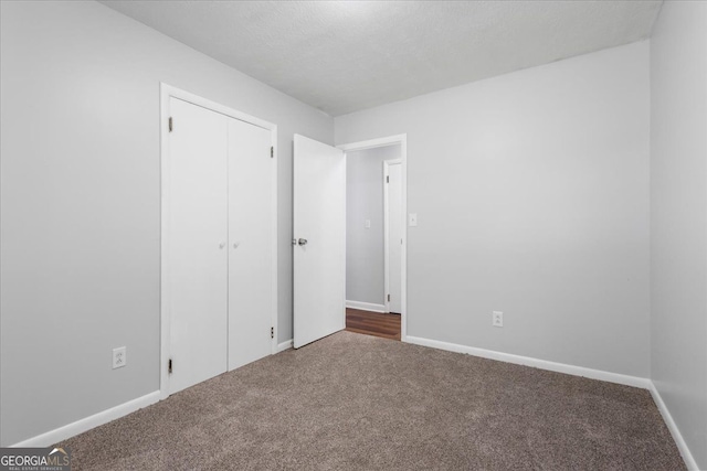 684 Hog Liver Rd, Carrollton, GA 30117 - unfurnished bedroom featuring carpet, baseboards, and a closet
