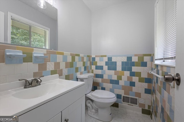 684 Hog Liver Rd, Carrollton, GA 30117 - bathroom featuring tile walls, toilet, wainscoting, and vanity