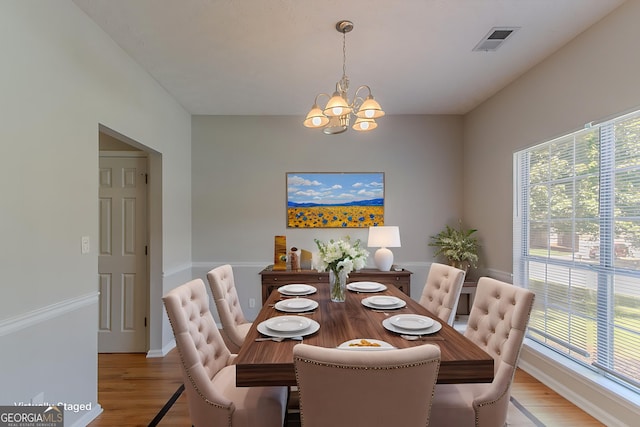12241 Cypress Way, Fayetteville, GA 30215 - dining space with light wood-style flooring, a chandelier, and baseboards