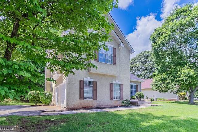 12241 Cypress Way, Fayetteville, GA 30215 - view of front of house featuring stucco siding, a front lawn, a garage, and driveway