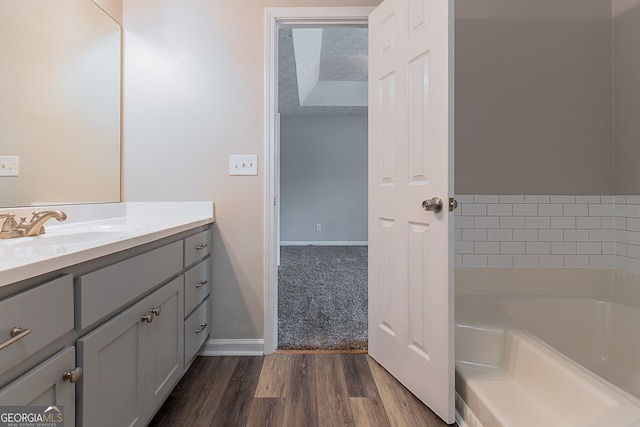 12241 Cypress Way, Fayetteville, GA 30215 - full bathroom with wood finished floors, vanity, a bath, and baseboards