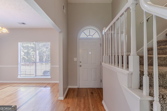 12241 Cypress Way, Fayetteville, GA 30215 - foyer entrance featuring wood finished floors, healthy amount of natural light, stairway, and baseboards