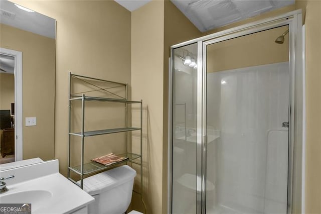 full bathroom featuring a shower stall, toilet, and vanity