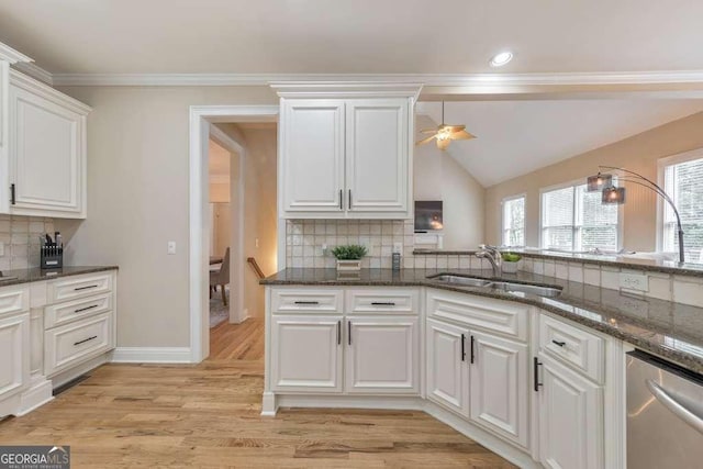 kitchen featuring a sink, white cabinetry, tasteful backsplash, stainless steel dishwasher, and a ceiling fan