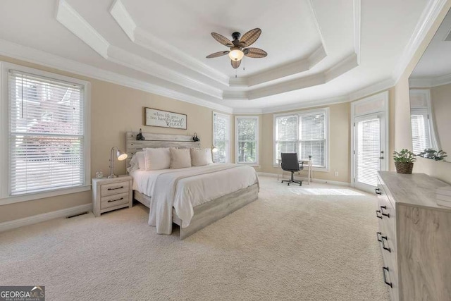 bedroom with crown molding, a raised ceiling, light colored carpet, baseboards, and ceiling fan