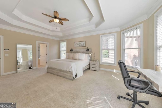 carpeted bedroom with a raised ceiling, crown molding, an office area, baseboards, and ceiling fan