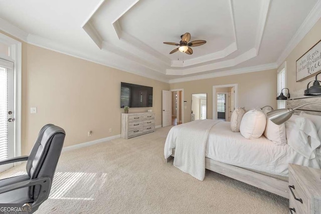 bedroom with a raised ceiling, light carpet, ornamental molding, baseboards, and a ceiling fan