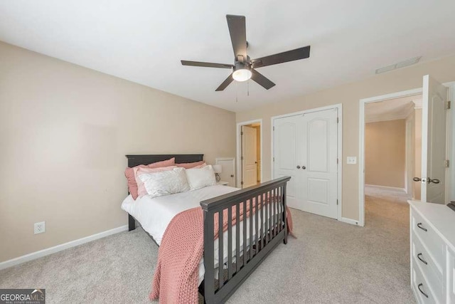 bedroom with light carpet, baseboards, and ceiling fan