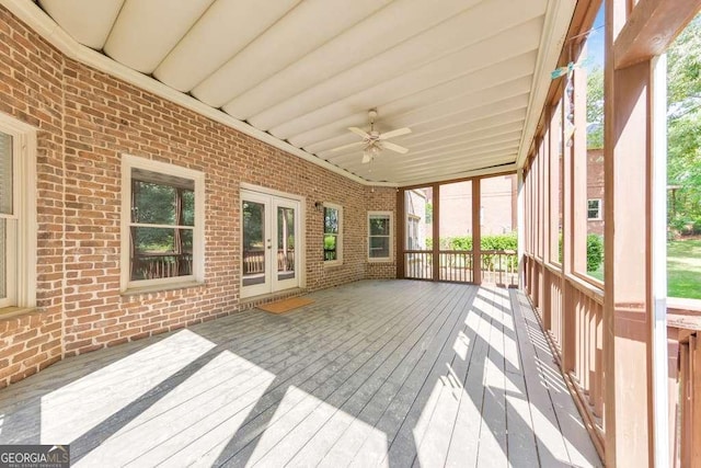 unfurnished sunroom with french doors, ceiling fan, and plenty of natural light