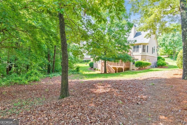 view of yard with stairs and a wooden deck