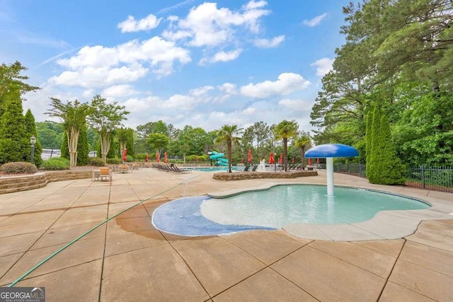 community pool featuring a patio area and fence
