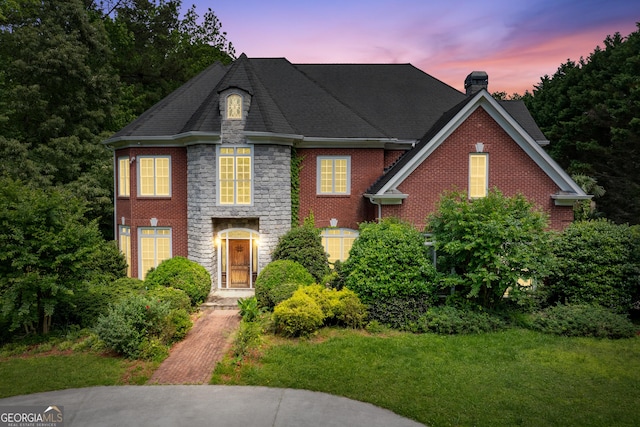 11569 Finley Rd, Johns Creek, GA 30024 - view of front of home featuring a chimney, stone siding, and a front yard