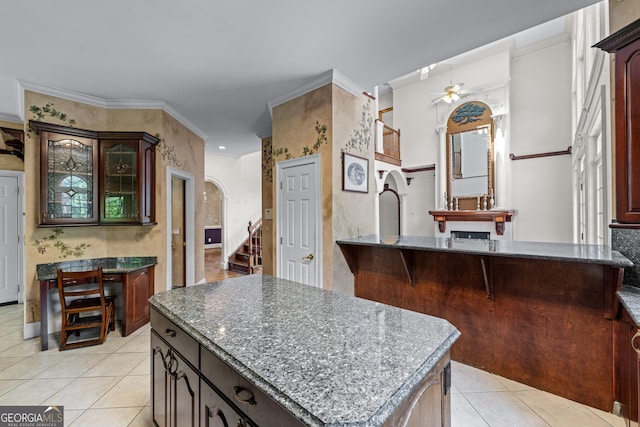11569 Finley Rd, Johns Creek, GA 30024 - kitchen featuring ceiling fan, light tile patterned flooring, dark stone counters, and glass insert cabinets