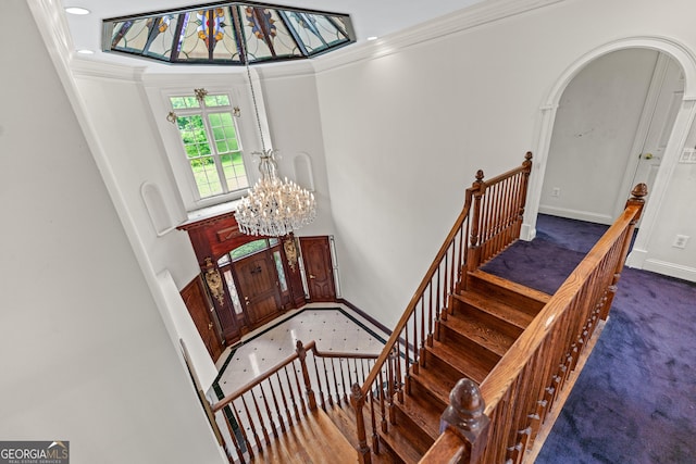 11569 Finley Rd, Johns Creek, GA 30024 - stairway with ornamental molding, carpet floors, a chandelier, arched walkways, and baseboards