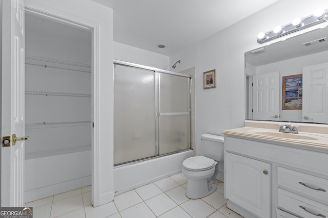 11569 Finley Rd, Johns Creek, GA 30024 - full bath with toilet, tile patterned flooring, vanity, and bath / shower combo with glass door