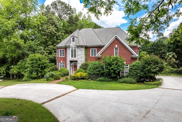 11569 Finley Rd, Johns Creek, GA 30024 - georgian-style home featuring a front lawn, concrete driveway, brick siding, and stone siding