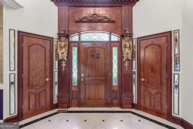11569 Finley Rd, Johns Creek, GA 30024 - foyer entrance featuring inlaid floor details, baseboards, a towering ceiling, tile patterned floors, and healthy amount of natural light