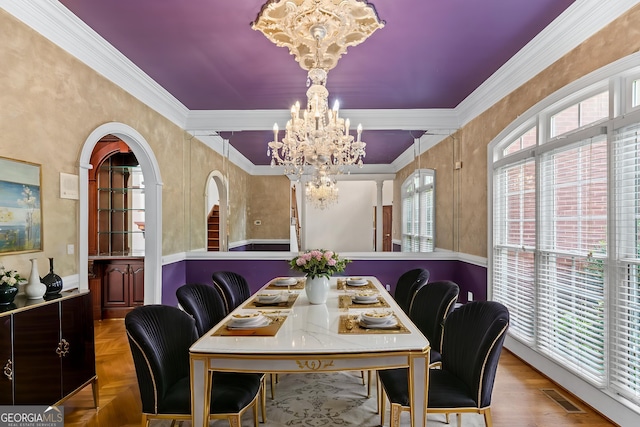 11569 Finley Rd, Johns Creek, GA 30024 - dining space featuring a chandelier, arched walkways, and ornamental molding
