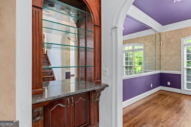 11569 Finley Rd, Johns Creek, GA 30024 - bar featuring ornamental molding, plenty of natural light, baseboards, wood finished floors, and arched walkways