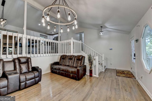 1358 Millstream Trl, Lawrenceville, GA 30044 - living room with vaulted ceiling, stairs, wood finished floors, baseboards, and a chandelier