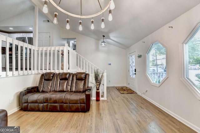 1358 Millstream Trl, Lawrenceville, GA 30044 - living area featuring lofted ceiling, wood finished floors, baseboards, and stairs
