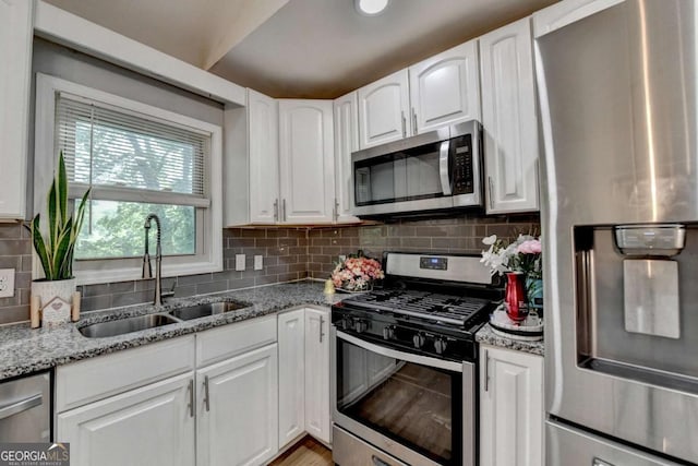 1358 Millstream Trl, Lawrenceville, GA 30044 - kitchen featuring stainless steel appliances, a sink, white cabinetry, backsplash, and light stone countertops