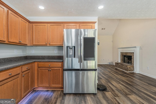 220 Windpher Rdg, Hampton, GA 30228 - kitchen with stainless steel refrigerator with ice dispenser, dark countertops, dark wood-type flooring, brown cabinetry, and a textured ceiling