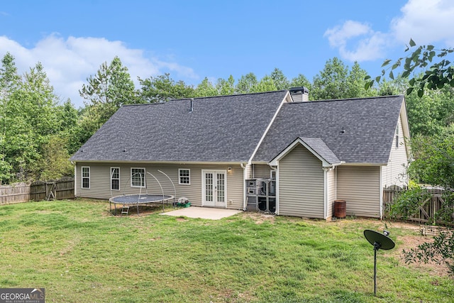 220 Windpher Rdg, Hampton, GA 30228 - back of property with french doors, a fenced backyard, a patio area, a shingled roof, and a chimney