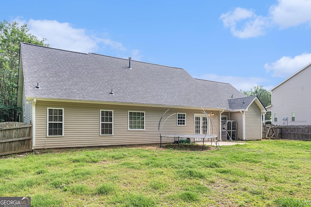220 Windpher Rdg, Hampton, GA 30228 - back of house featuring a trampoline and roof with shingles