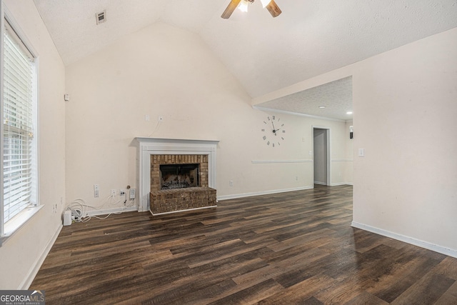 220 Windpher Rdg, Hampton, GA 30228 - unfurnished living room featuring a ceiling fan, vaulted ceiling, wood finished floors, a fireplace, and baseboards