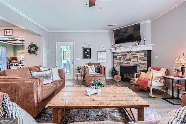 837 Brown Thrasher Way, Bremen, GA 30110 - living area featuring wood finished floors, ornamental molding, ceiling fan, and a stone fireplace
