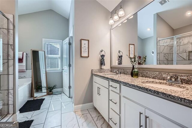837 Brown Thrasher Way, Bremen, GA 30110 - bathroom featuring lofted ceiling, a shower stall, marble look tiles, double vanity, and a garden tub