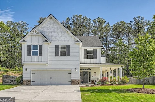 837 Brown Thrasher Way, Bremen, GA 30110 - view of front of house with board and batten siding, stone siding, a porch, and an attached garage