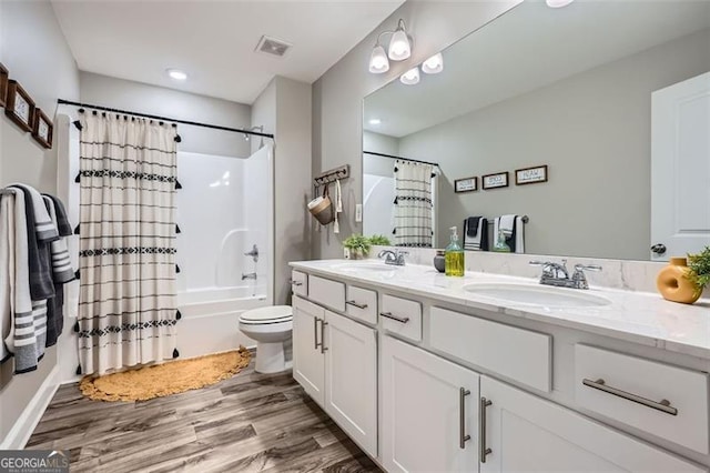837 Brown Thrasher Way, Bremen, GA 30110 - full bath featuring wood finished floors, double vanity, shower / bathtub combination with curtain, and toilet
