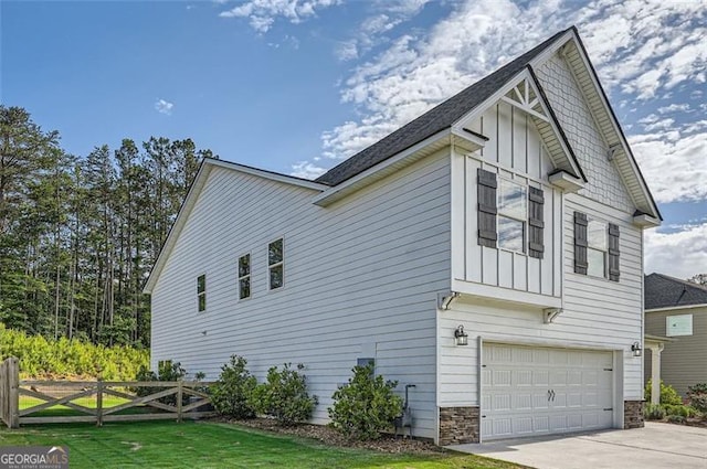 837 Brown Thrasher Way, Bremen, GA 30110 - view of property exterior with board and batten siding, fence, an attached garage, concrete driveway, and stone siding
